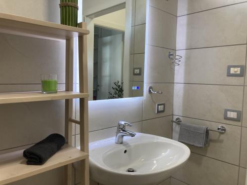 a bathroom with a sink and a mirror at Outdooredo Garda Torbole in Nago-Torbole