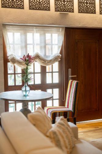 a living room with a table and a vase with a flower at Blerina's Agritourism Concept in Laknas