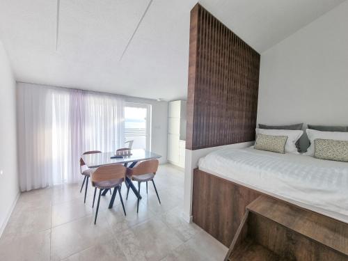 a bedroom with a bed and a table and chairs at Adria Mare in Crikvenica