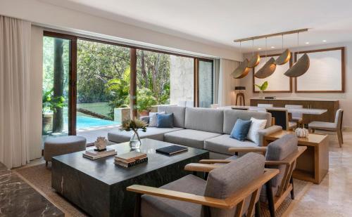 a living room with a couch and a table at Fairmont Mayakoba in Playa del Carmen