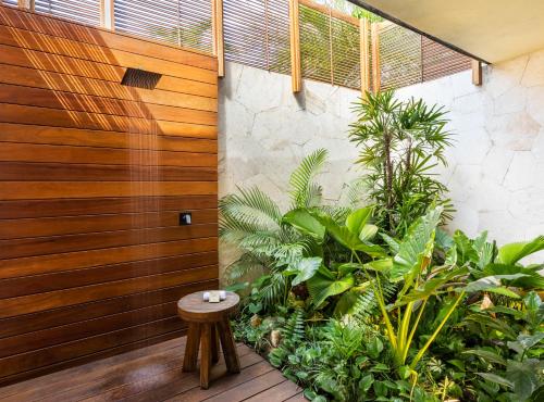a room with plants and a wooden wall at Fairmont Mayakoba in Playa del Carmen