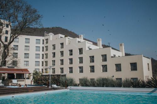 a large white building with a pool in front of it at Sheraton Salta Hotel in Salta
