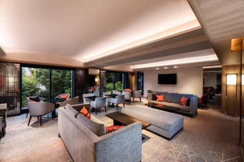 a hotel lobby with couches and tables and windows at Sheraton Miyako Hotel Tokyo in Tokyo