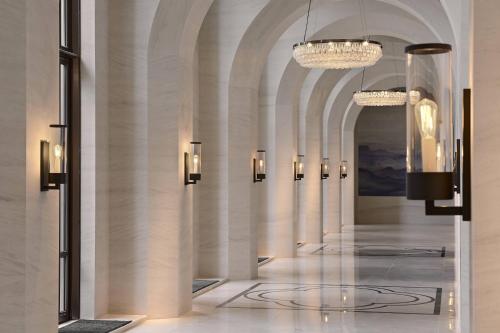 a lobby with a hallway with chandeliers at Taipei Marriott Hotel in Taipei