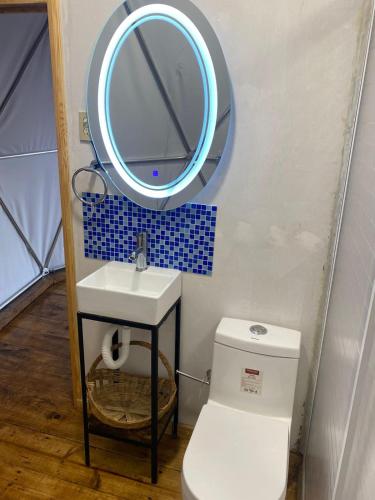 a bathroom with a sink and a mirror over a toilet at MANDALA CAMP in Tomatlán