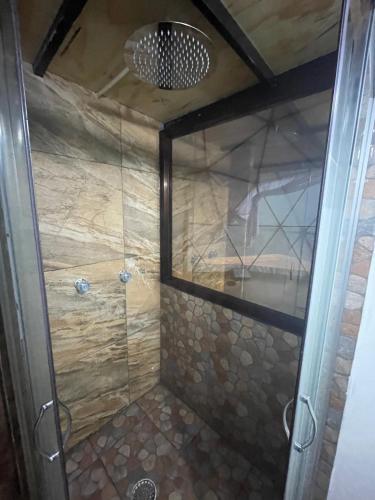 a shower with a glass door in a bathroom at MANDALA CAMP in Tomatlán