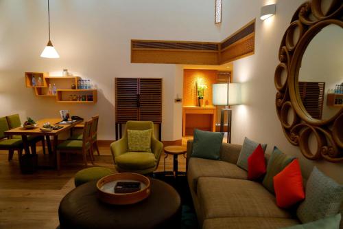 a living room with a couch and a table at The Westin Sohna Resort & Spa in Gurgaon