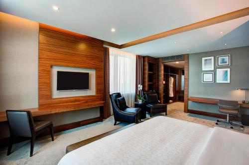 a hotel room with a bed and a flat screen tv at Sheraton Grand Samsun Hotel in Samsun