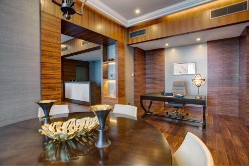 a dining room with a table and a desk at Sheraton Grand Samsun Hotel in Samsun