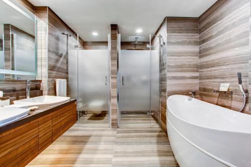a bathroom with a tub and two sinks at Sheraton Grand Samsun Hotel in Samsun