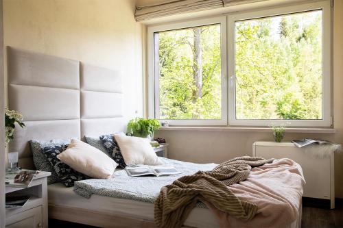 a bedroom with a bed with a window at Sarnówka KDN in Rajcza
