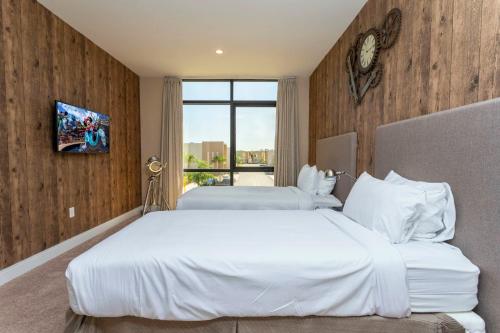 a hotel room with two beds and a window at Magical 4suites Home w jacuzzi near Disney 7497 in Orlando