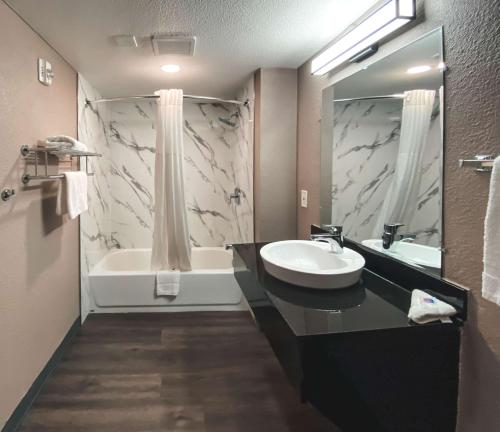 a bathroom with a sink and a bath tub at Motel 6-West Sacramento, CA in West Sacramento