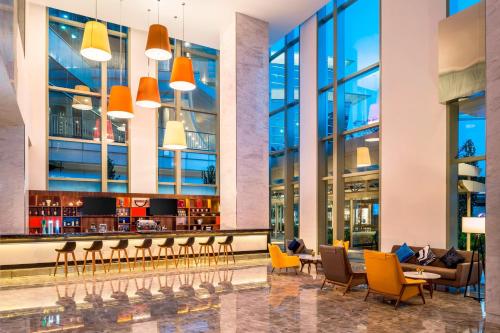 a lobby of a building with chairs and a bar at Le Meridien Putrajaya in Putrajaya
