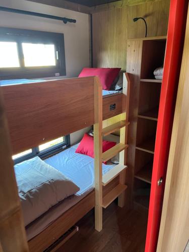 a couple of bunk beds in a small room at DOMAINE DES GALINACES ROULOTTE LA ROUSSETTE 2-4P in Marigny-lès-Reullée