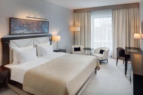 A bed or beds in a room at Grand Hotel River Park, a Luxury Collection Hotel, Bratislava