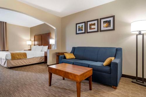 a hotel room with a couch and a bed at Comfort Inn & Suites Oxford South in Oxford