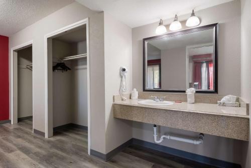 a bathroom with a sink and a mirror at SureStay Plus Hotel by Best Western San Antonio North in San Antonio