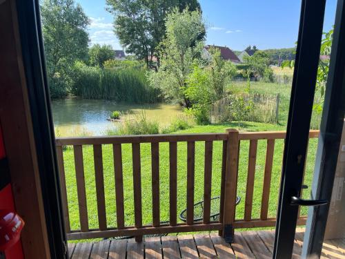 a view of a river from a porch at DOMAINE DES GALINACES ROULOTTE LA ROUSSETTE 2-4P in Marigny-lès-Reullée