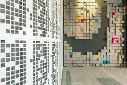 a room with a wall covered in tiles at Aloft Dubai Creek in Dubai