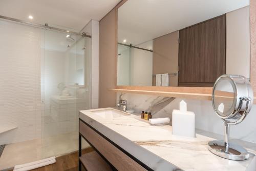 a bathroom with a sink and a mirror at Residence Inn by Marriott Bogota in Bogotá
