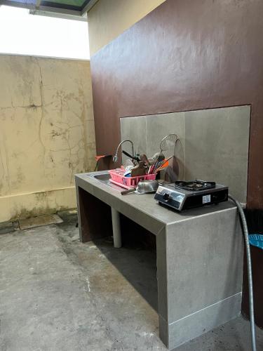 a table with a pile of clutter on top of it at Casa Familia Syariah in Sleman