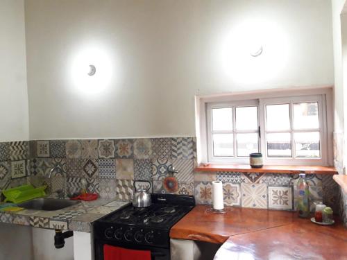 a kitchen with a stove and a counter top at El Bosquecito, Casita rodeada de bosque in San Esteban