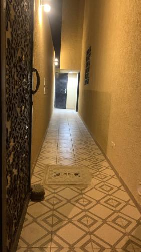 a hallway with a door and a tile floor at شقق العارض 1 in Riyadh