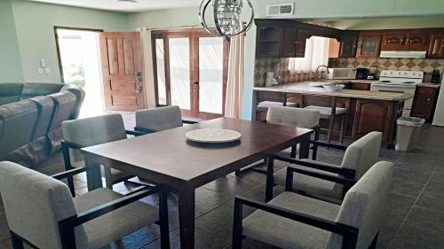 a kitchen and dining room with a table and chairs at Villa Sonari 4, Inside a private complex of 4 By Kivoya in Puerto Peñasco