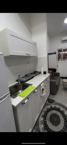 a kitchen with a sink and a counter top at דירה מדהימה קטנטנה תאהבו אותה ، A small, beautiful and comfortable apartment, you will love in Haifa