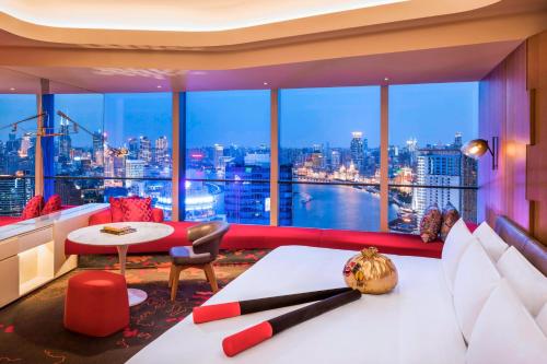 a hotel room with a view of a city at W Shanghai - The Bund in Shanghai