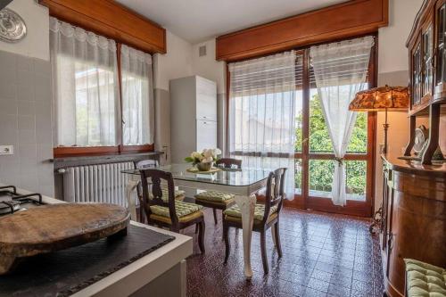 a kitchen with a table and chairs in a room at Villa Gabri in Arona