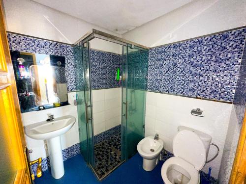 a bathroom with a shower and a toilet and a sink at Diamond of Mekkade, Sea view with swimming pool in Oued Laou