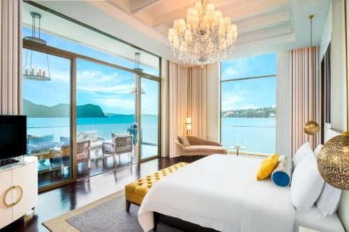 a bedroom with a large white bed and a large window at The St. Regis Langkawi in Kuah