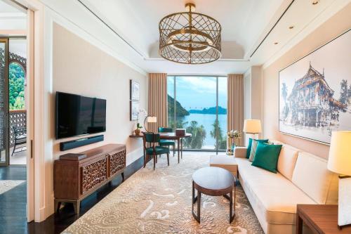 a living room with a couch and a tv at The St. Regis Langkawi in Kuah