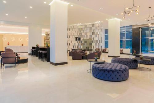 a lobby with couches and chairs and a reception desk at Four Points by Sheraton Cuenca in Cuenca