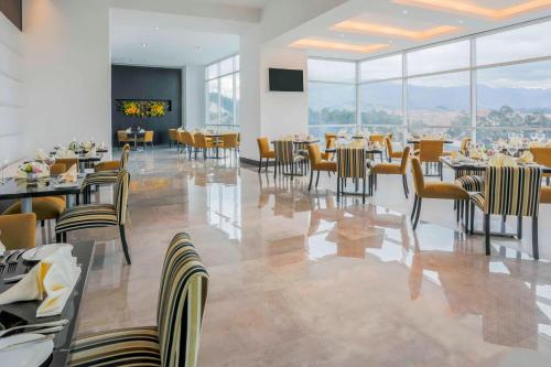 a restaurant with tables and chairs with a view at Four Points by Sheraton Cuenca in Cuenca