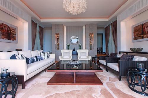 a living room with white furniture and a chandelier at The Westin Langkawi Resort & Spa in Kuah