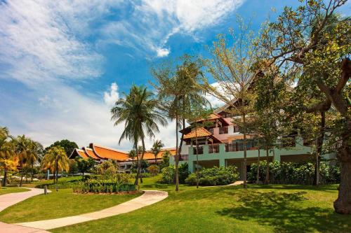 a building in a park with palm trees at The Westin Langkawi Resort & Spa in Kuah