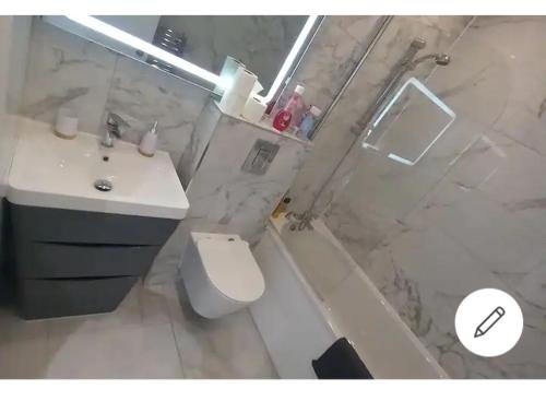 a bathroom with a sink and a toilet and a shower at Flat 22, Spacious two bedroom apartment in Canvey