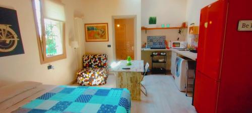 - une cuisine avec un lit et une chaise dans la chambre dans l'établissement CASETTO ROSSO, à San Lazzaro di Savena