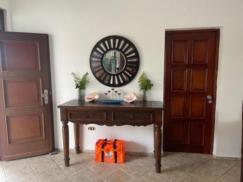 a wooden table with a mirror on a wall at Ocean Breeze Villa Carismar in Cabrera