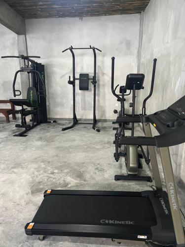 a gym with several tread machines and a treadmill at Waiwas Hostel in Kuta Lombok
