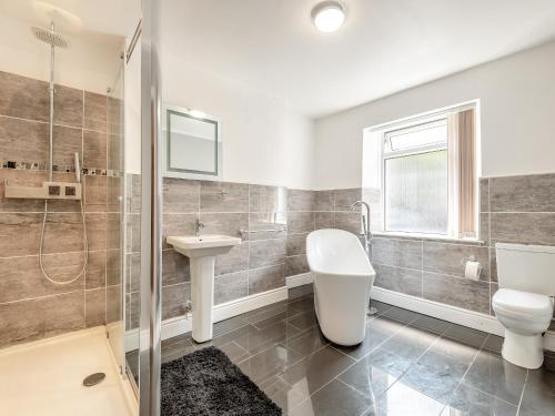 a bathroom with a toilet sink and a shower at The Coffee House in Coleford