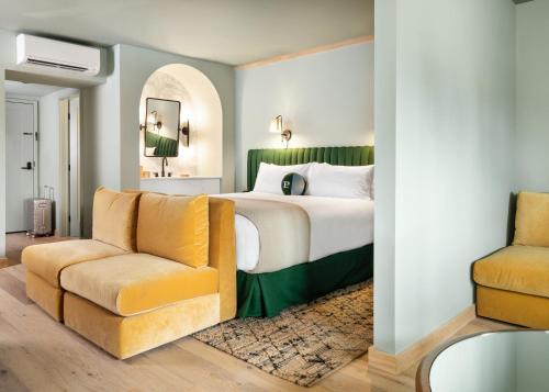 a bedroom with a bed and a chair at Palihotel Hollywood in Los Angeles