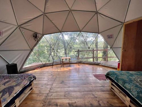 a room with two beds in a dome tent at MANDALA CAMP in Tomatlán