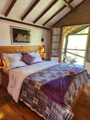 a bedroom with a large bed in a room at Pousada Vale Monte Azul in Santo Antônio do Pinhal