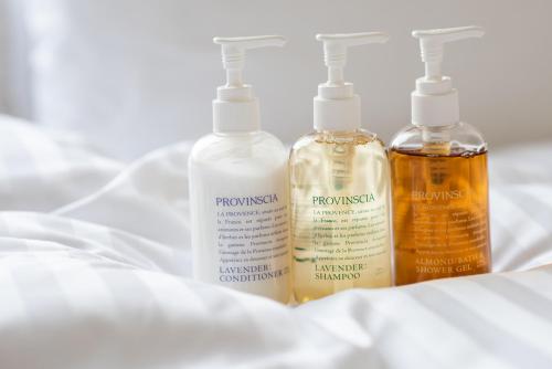 a group of three bottles sitting on a bed at Hotel Vista Tokyo Tsukiji in Tokyo