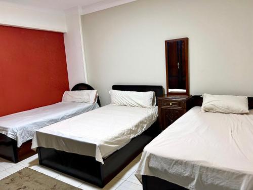 a room with two twin beds and a dresser at سى فيو السريا in Alexandria
