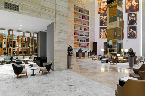 a lobby of a hotel with couches and chairs at Sheraton Batumi Hotel in Batumi